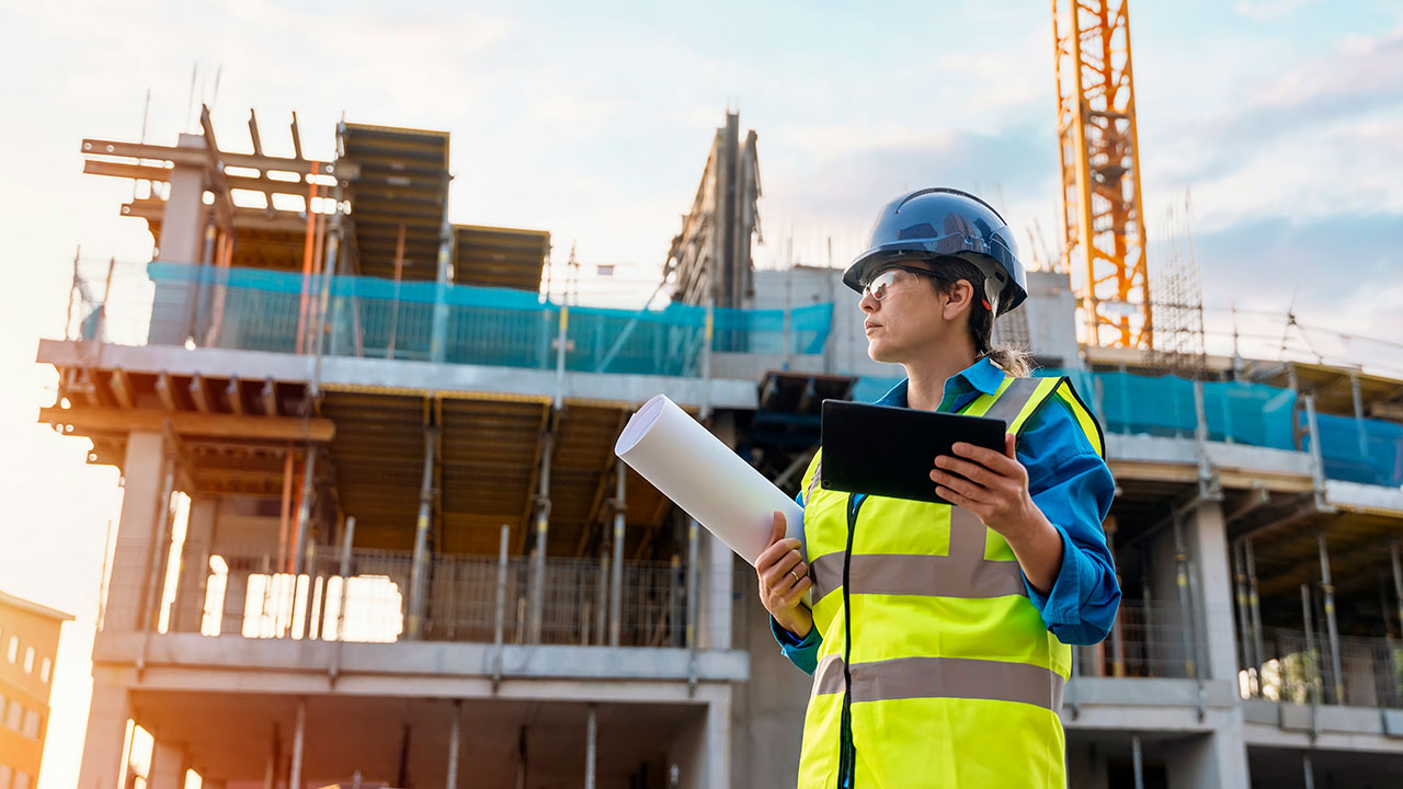 Construction field worker reviewing construction project progress