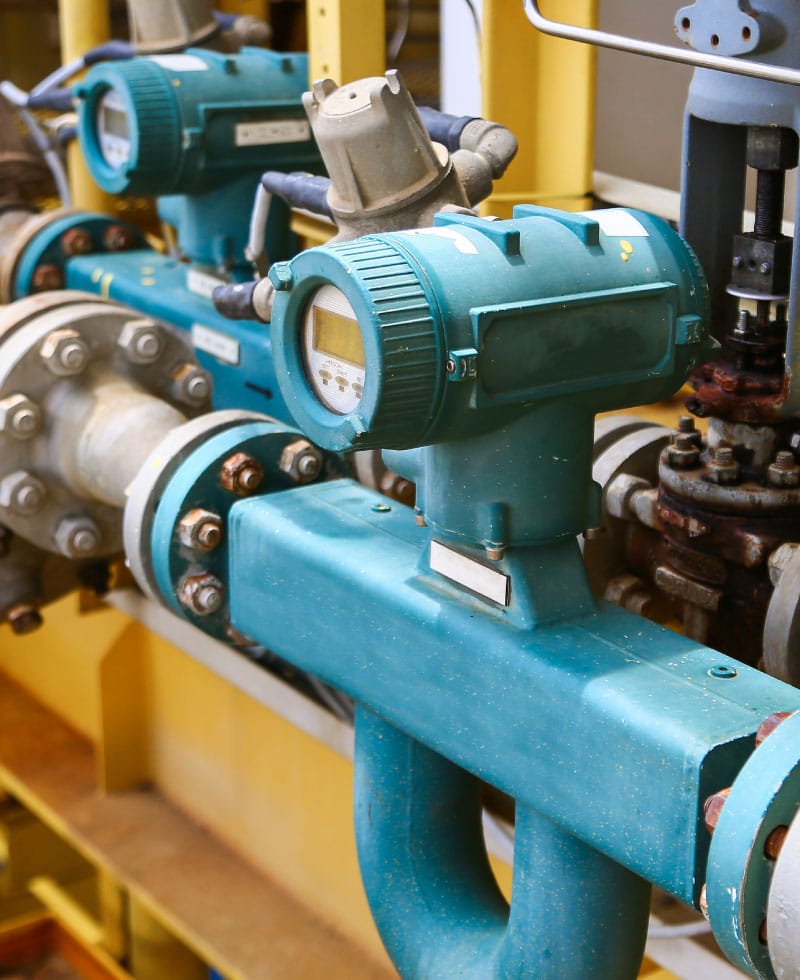 Flow computer instruments mounted on industrial piping.